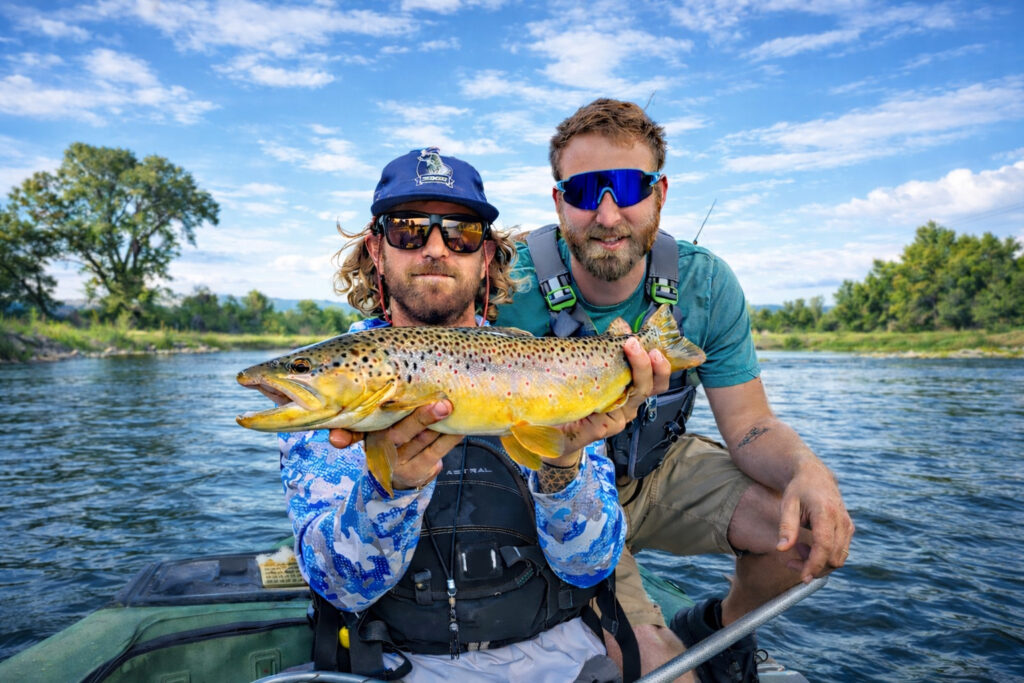 Two anglers displaying trophy brown trout during Rio Grande River trout fishing trip in Colorado
